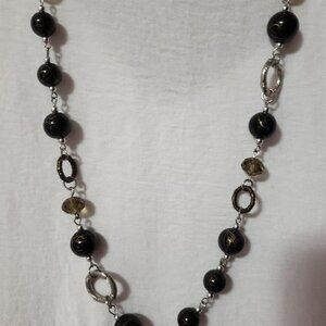 Neklace design on black beads.